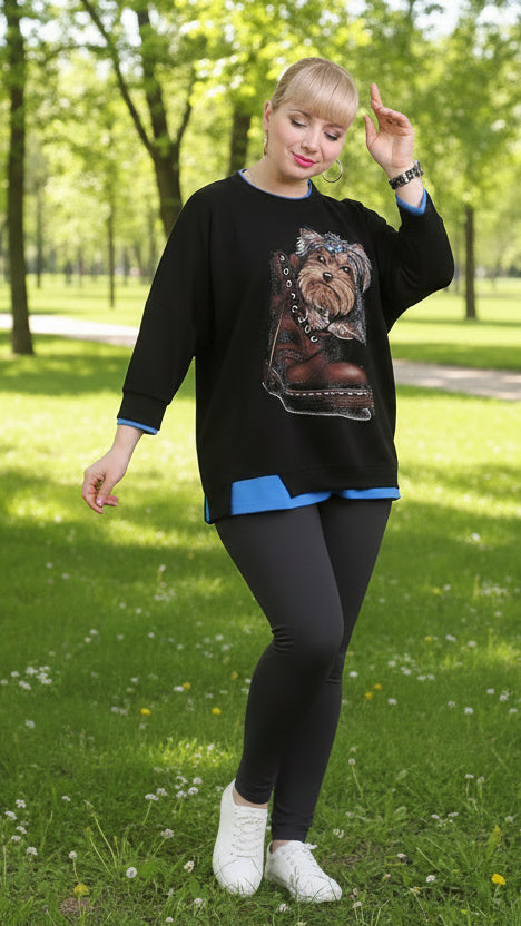 A woman wearing a black t-shirt with a printed image of a yorkie on the front.